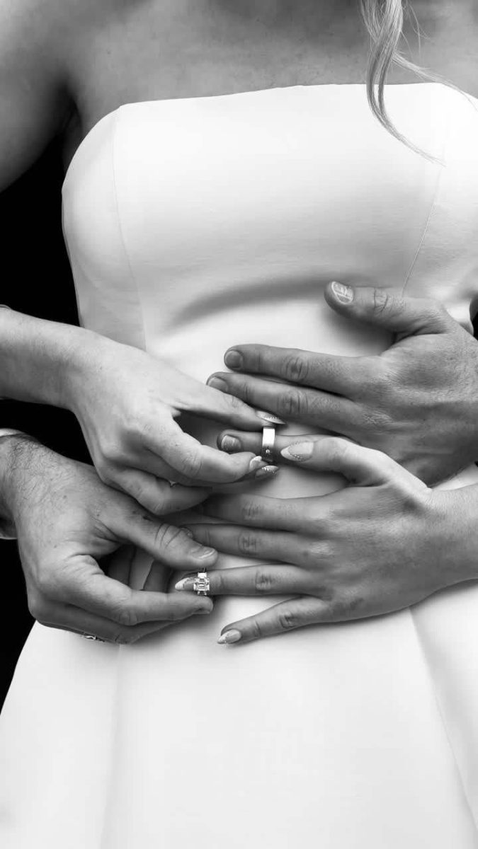 Black and white bride adjusting her gown